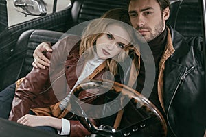 beautiful stylish young couple in leather jackets embracing