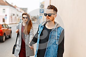 Beautiful stylish young couple with sunglasses in trendy clothes.