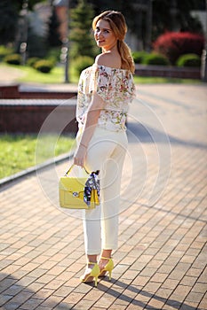 Beautiful stylish young girl on the background of the city. Fashionable young gi