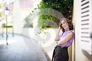 Beautiful successful middle aged woman posing on the street of the old city