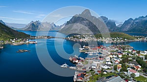 Beautiful summer aerial view of Reine, Norway, Lofoten Islands, with skyline, mountains, famous fishing village with red fishing c photo