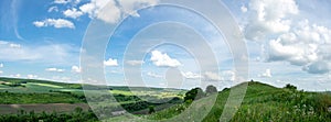 Beautiful summer countryside landscape against the background of blue sky and white clouds