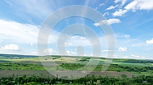 Beautiful summer countryside landscape against the background of blue sky and white clouds