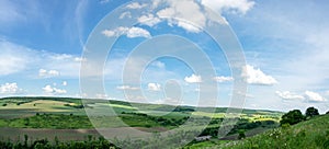 Beautiful summer countryside landscape against the background of blue sky and white clouds