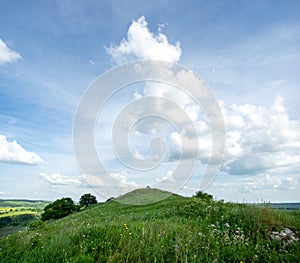 Beautiful summer countryside landscape against the background of blue sky and white clouds