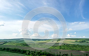 Beautiful summer countryside landscape against the background of blue sky and white clouds