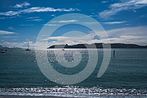 Beautiful summer evening at Bay of Islands. Leisure boats scattered on sparkling water. Northland, New Zealand