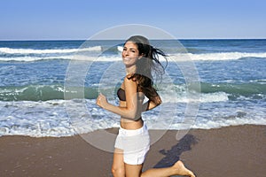 Beautiful summer girl jumping on the beach