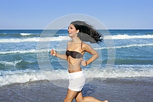 Beautiful summer girl jumping on the beach