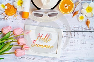 Beautiful summer holiday, Beach accessories, orange, sunglasses, hat and shells on wooden backgrounds