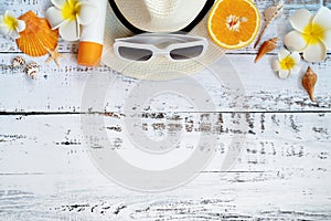 Beautiful summer holiday, Beach accessories, orange, sunglasses, hat and shells on wooden backgrounds