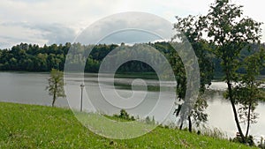 Beautiful summer landscape with lake, boat and greenery