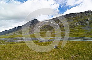 A beautiful summer landscape of mountain river in Sarek National Park, Sweden.