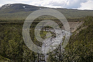 A beautiful summer landscape of mountain river in Sarek National Park, Sweden.