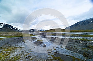 A beautiful summer landscape of mountain river in Sarek National Park, Sweden.