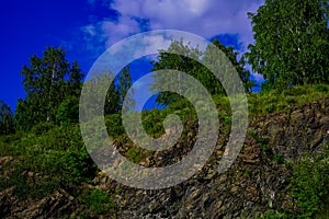 Beautiful summer landscape of nature - rocks, greenery, blue sky