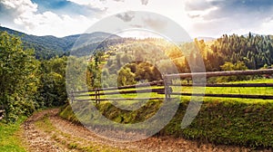 Beautiful summer landscape with wooden fence and mountains. blue