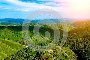 Beautiful summer mountain landscape with blue smoke and forest. Kazakhstan Almaty, Aktas Plateau and Bukreev Peak.