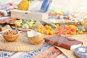 Beautiful summer picnic on the beach at sunset in zero waste style. Eco friendly idea for weekend staycations.