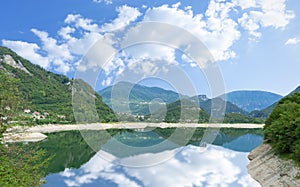 Beautiful summer scenery of Lake Corlo in Italy surrounded by the Alps.