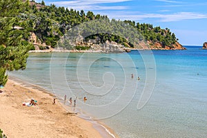 Beautiful Summer scenery with a lot of swimmers at Chrisi Milia beach in Alonissos island, Greece