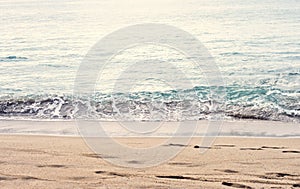 Beautiful summer season specific photograph. Calm beach/shore waves. Rich blue/turquoise marine/ocean colors. Lovely lights and su