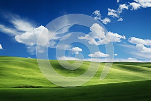 A beautiful summer or spring landscape with green grass on the hills and green fields. The blue sky is filled with white