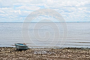 Beautiful summer spring nature of the Saratov region. Cloudy day on the Volga River, Russia. Old boat on the shore