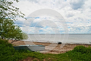 Beautiful summer spring nature of the Saratov region. Cloudy day on the Volga River, Russia. Old boat on the shore