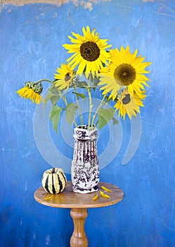 Beautiful summer sunflowers in old ceramic vase