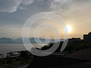 Beautiful summer sunset sunrise over Mediterranean sea with mountains silhouettes. Horizontal image