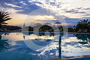 Beautiful summer sunset by the swimming pool