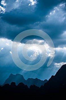 Beautiful sun rays through the clouds over mountains,evening light,Amazing scene at Khao-Sok National Park of Thailand