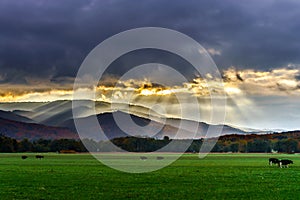 Beautiful sun rays through the clouds over mountains