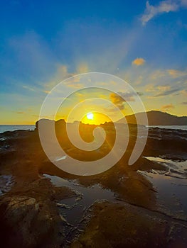 Beautiful sunbeam on extreme terrain from a rocky coast photo