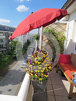 beautiful sunny balcony with flowers and parasol