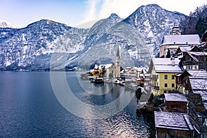 beautiful sunny cityscape of the special city Hallstatt in Austria Salzkammergut snowy winter mountains and lake and