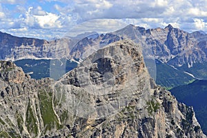 Beautiful sunny day in Dolomites, blue sky, white clouds, high mountains.