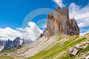 Beautiful sunny day in Dolomites mountains. View on Tre Cime di Lavaredo with shelter. Three famous mountain peaks