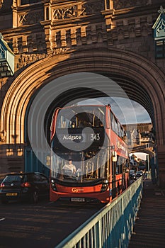 Beautiful sunny evening sunset view of the Red Bus on Tower Bridge with the cloudy blue sky