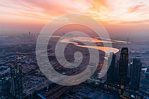 Beautiful sunrise above Dubai skyline, United Arab Emirates, aerial panoramic view from above from rooftop