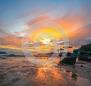 beautiful sunrise above fishing boats on the beach