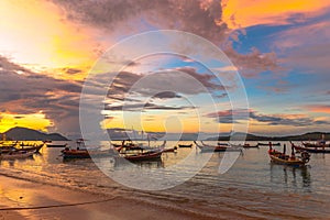 beautiful sunrise above fishing boats on Rawai beach,