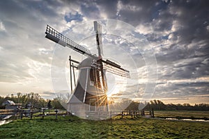 Beautiful sunrise behind Dutch windmill