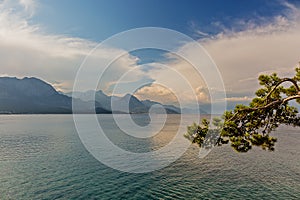 Mountains and clouds are reflected in the sea water. City Of Kemer, Turkey.