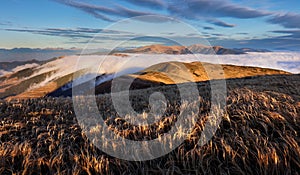 Beautiful sunrise. Clouds over the mountains. Autumn Landscape