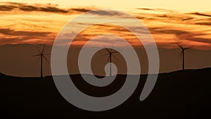 Beautiful sunrise dawn landscape with wind turbine generating electricity, time-lapse 4k