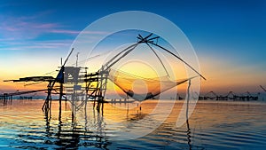 Beautiful sunrise and fishing dip nets at Pakpra in Phatthalung, Thailand.
