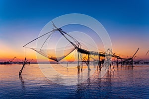 Beautiful sunrise and fishing dip nets at Pakpra in Phatthalung, Thailand