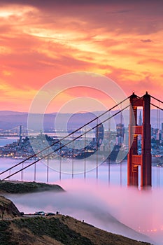 Beautiful sunrise at Golden Gate Bridge in Low Fog